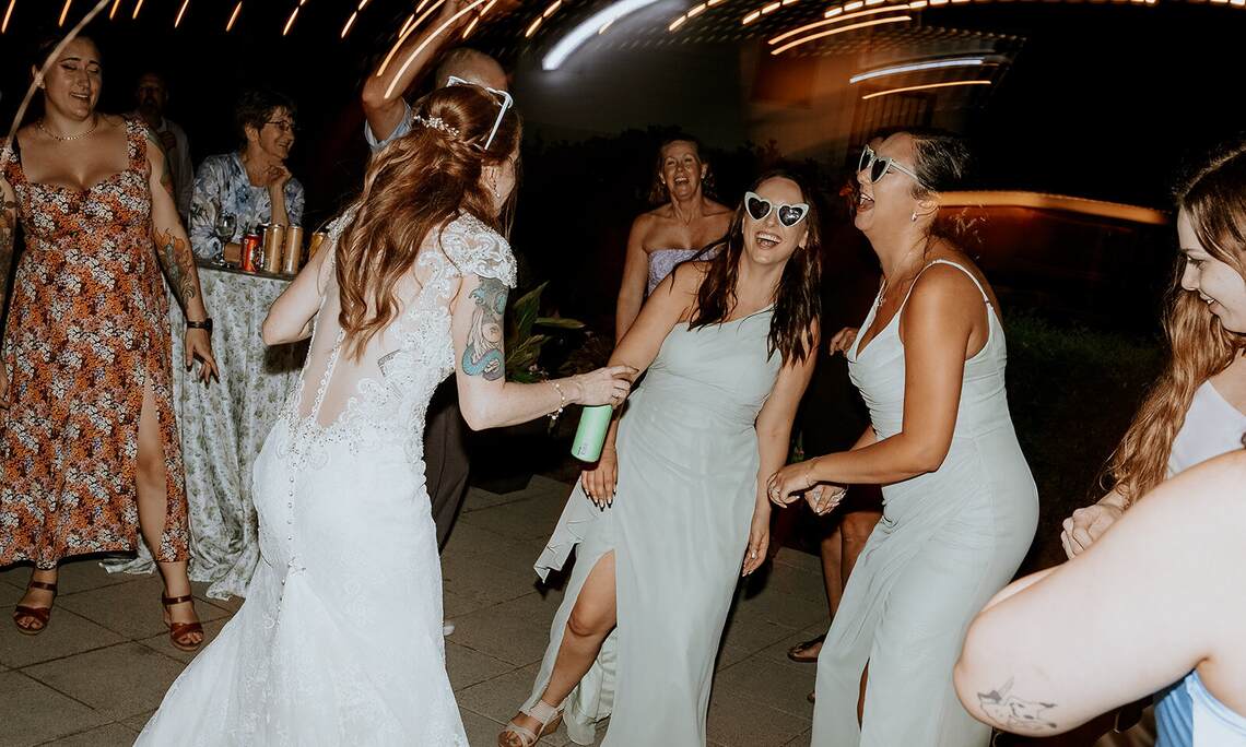 The wedding party and guests dancing at an outdoor reception at Sandpiper Resort, Harrison Mills