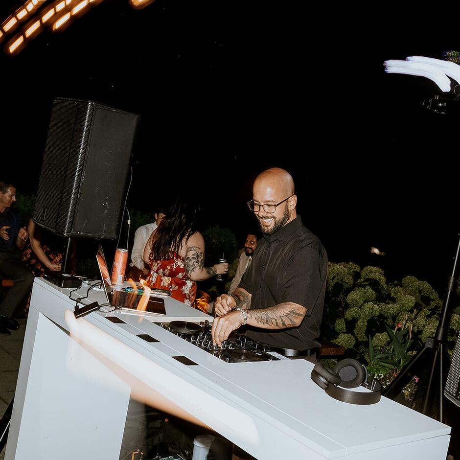Zack Braddick of Pardy DJ Co. mixing at the booth during a wedding reception at Sandpiper Resort, Harrison Mills